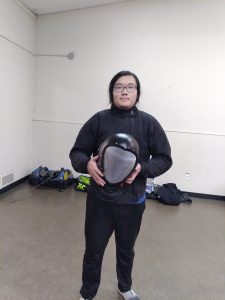 Jason Wang, sportsmanship award, holding his Cobra mask.
